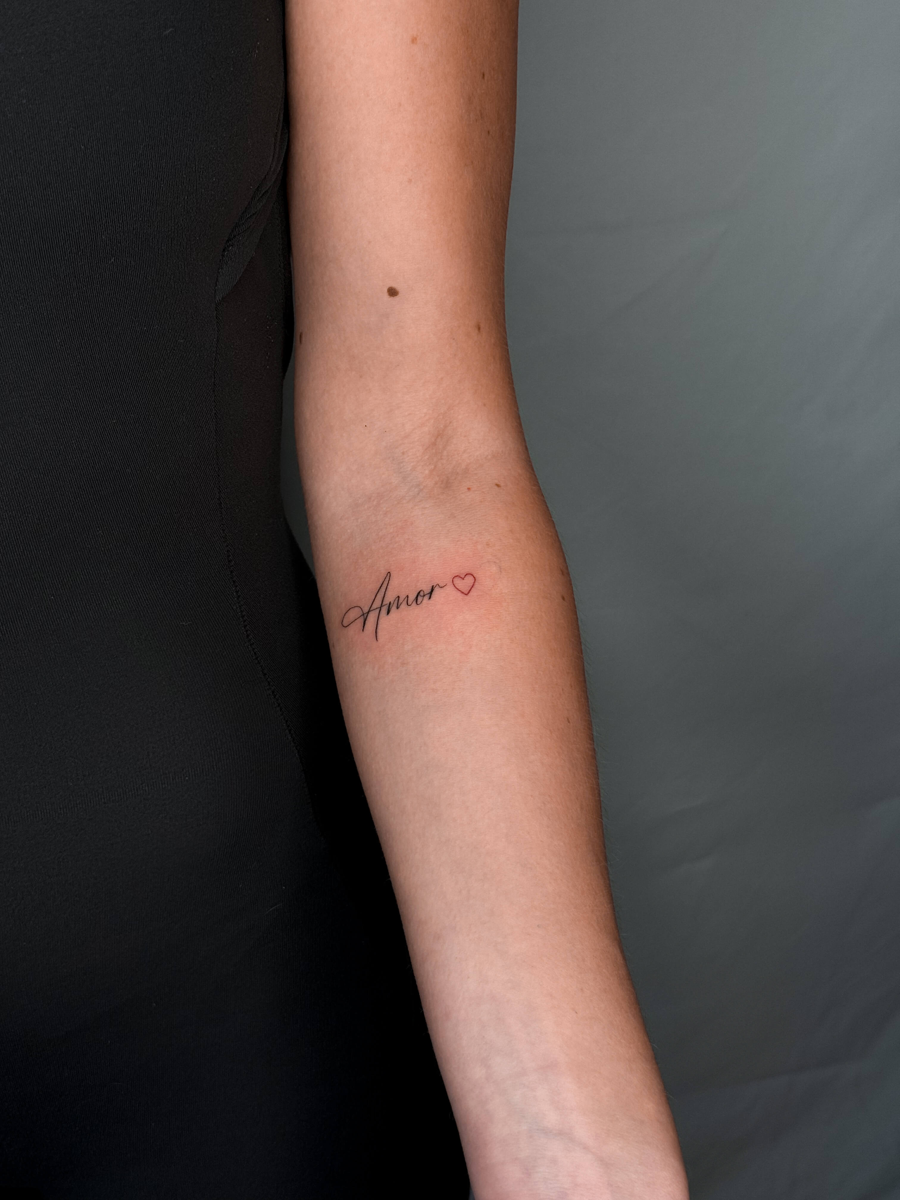 Fine line lettering tattoo on the forearm
